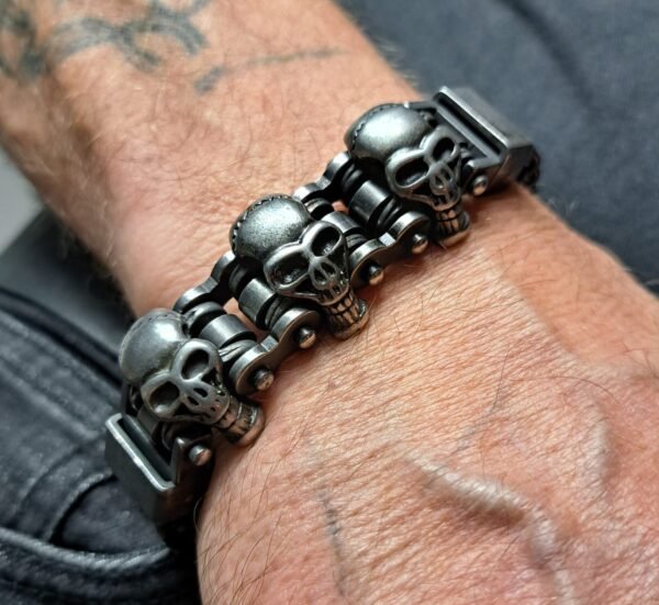 Skull biker bracelet worn on a wrist, showing its gothic chain design and bold skull details.