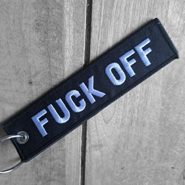 Close-up of Fuck Off embroidery on biker keytag