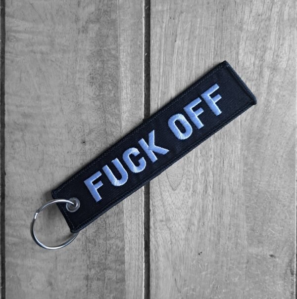 Fuck Off embroidered black biker keytag on wooden surface