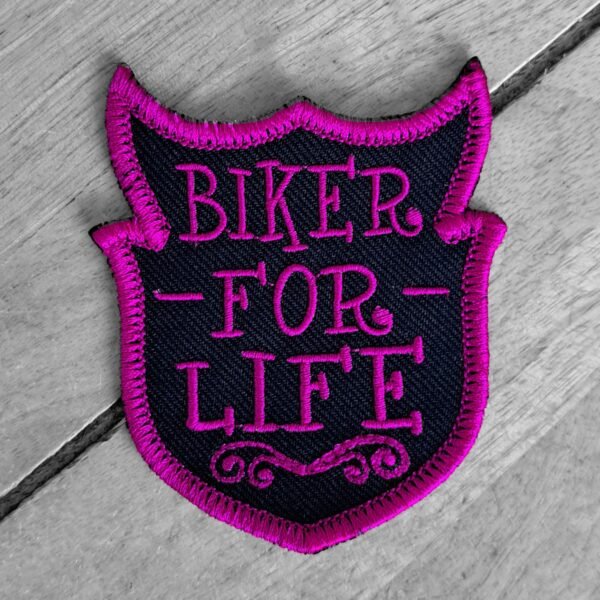 Shield-shaped biker for life patch with pink embroidery that says “Biker for Life,” designed for female motorcycle riders