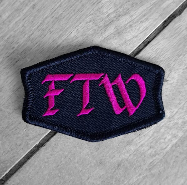 FTW patch in pink gothic letters on a black background, sew-on badge for female riders.