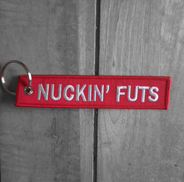 Funny novelty red keyring with NUCKIN’ FUTS text in white embroidery (horizontal view)