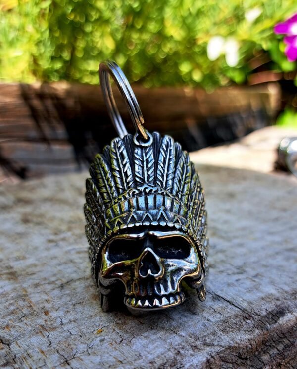 Close-up detail of tribal skull gremlin bell with feather headdress