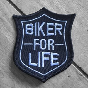 Embroidered biker patch with bold blue text “Biker for Life” in a badge-style shield on black fabric.
