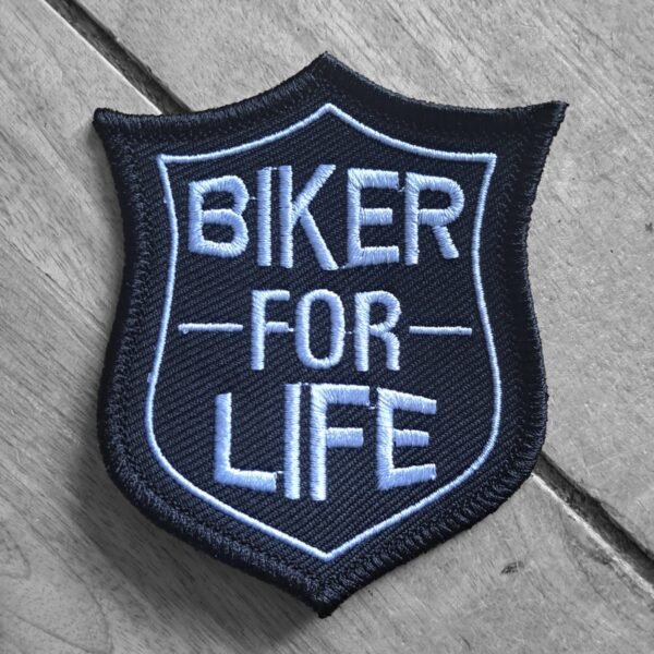 Embroidered biker patch with bold blue text “Biker for Life” in a badge-style shield on black fabric.