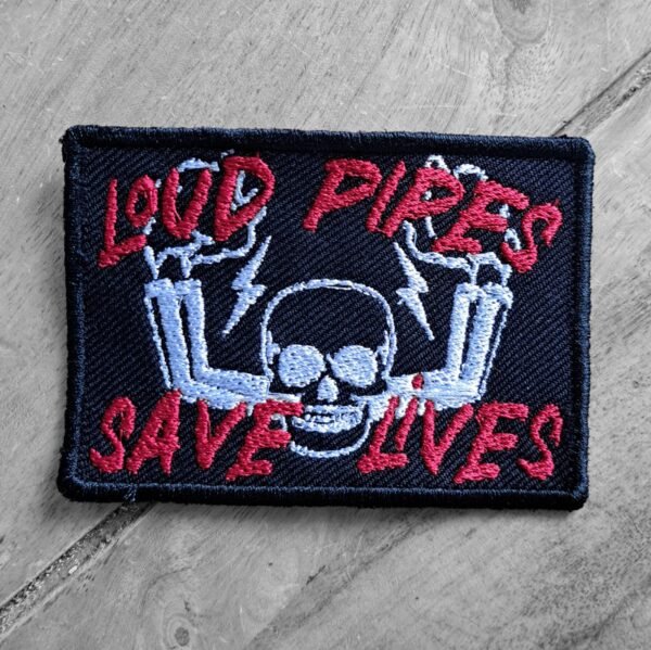 Embroidered biker patch with skull and exhaust pipes, featuring the text "Loud Pipes Save Lives" in red on dark background.