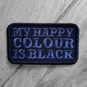 Black embroidered patch with bold purple-blue thread reading “My Happy Colour Is Black” in all-caps text.