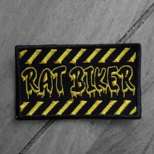 Embroidered “Rat Biker” patch with dripping yellow text and black background with yellow diagonal caution stripes.