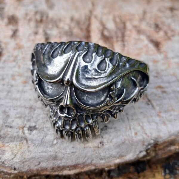 Front view of gothic skull stainless steel bangle with flames and biker heavy metal design, 69mm diameter.