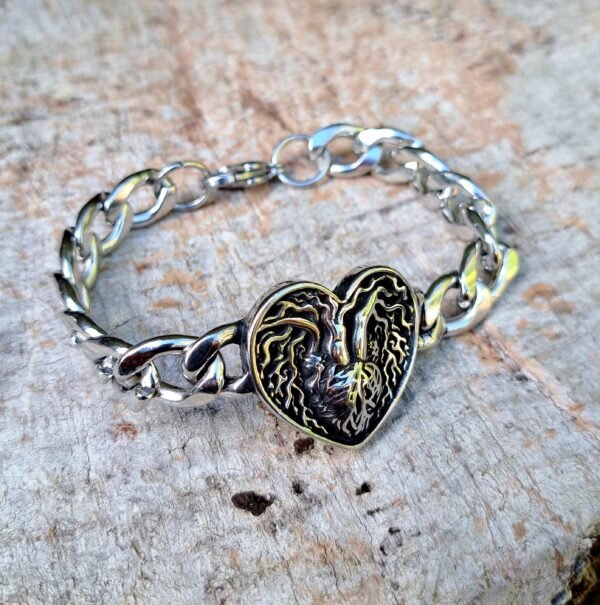 Stainless steel bracelet with heart shaped Tree of Life design on rustic wood