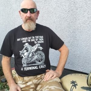 Man wearing Mad Max Goose MFP Z1000 t-shirt sitting on a desert-style motorcycle