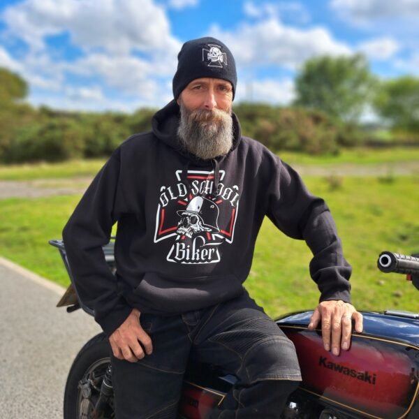 Black Old School Biker hoodie with skull graphic and “Old School Biker” text worn beside a motorcycle outdoors.