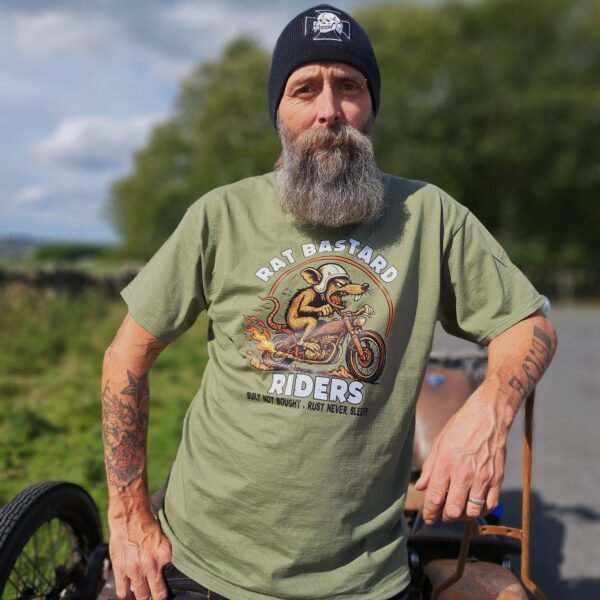 Close-up of Rat Bastard Riders print on olive t-shirt showing hot-rod rat, flames, and text Built Not Bought, Rust Never Sleeps by Rat-Ryder.