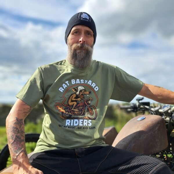 Olive green Rat Bastard Riders t-shirt by Rat-Ryder with hot-rod rat motorcycle graphic and “Built Not Bought, Rust Never Sleeps” slogan.