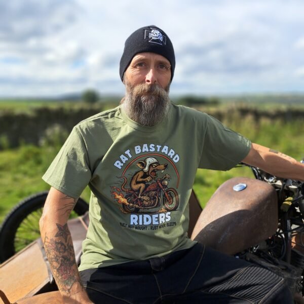 Olive green Rat Bastard Riders t-shirt by Rat-Ryder with hot-rod rat motorcycle graphic and “Built Not Bought, Rust Never Sleeps” slogan.