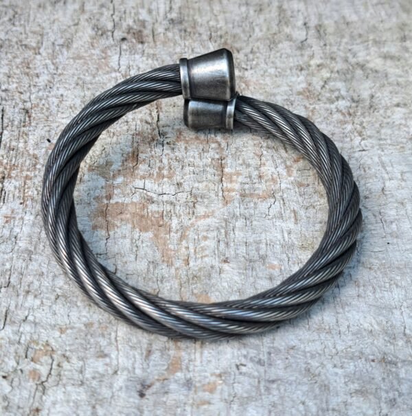 Top view of open-ended stainless cable cuff with antiqued finish; 9mm braid, 13mm end caps