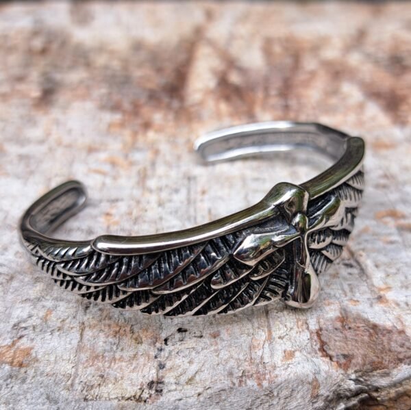 Side view of stainless steel winged cross bangle, angel wings gothic jewelry