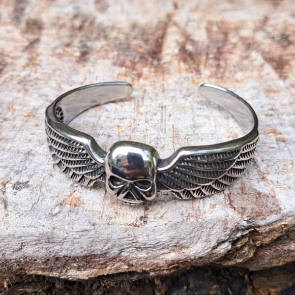 Front view of stainless steel winged skull bangle, gothic biker and heavy metal jewelry
