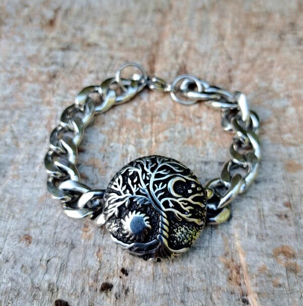 Stainless steel Tree of Life bracelet with sun and moon design on wooden background