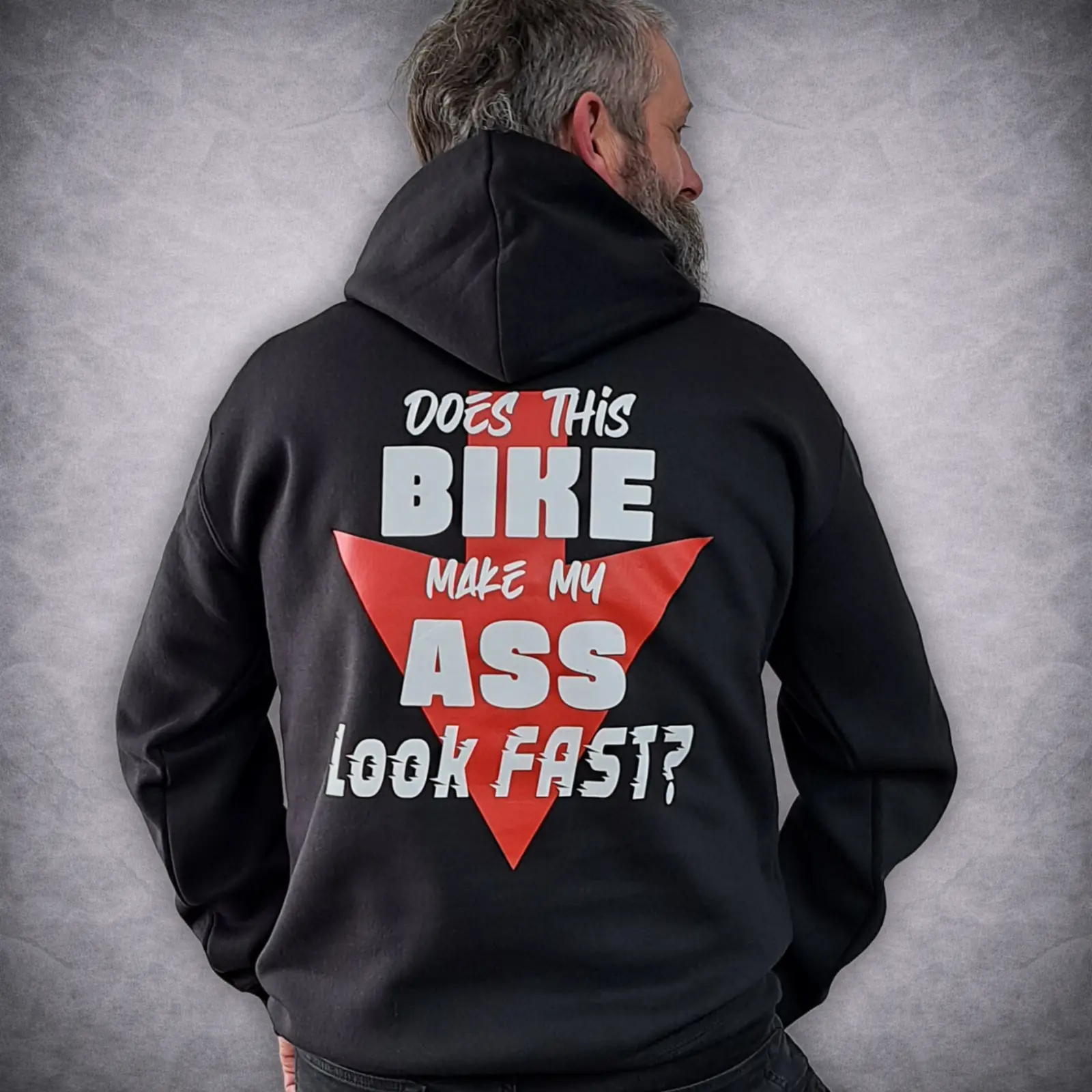 Funny Biker Hoodie – Does This Bike Make My Ass Look Fast? Motorcycle Hoodie 3 Close up details of the back text graphic on a funny biker hoodie reading 'Does this bike make my ass look fast?' worn by a man with a beard looking away.