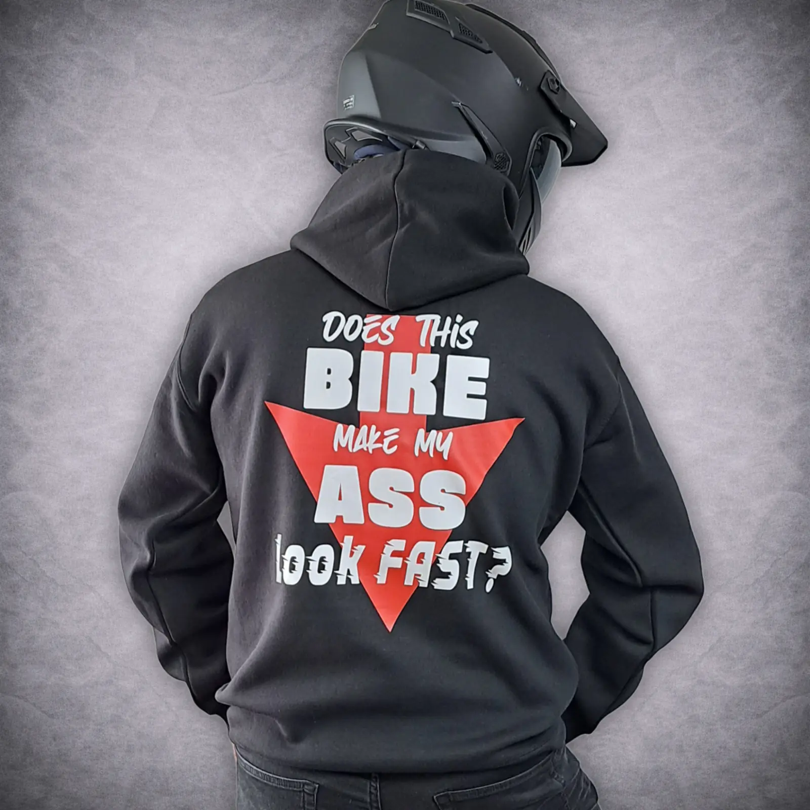 Funny Biker Hoodie – Does This Bike Make My Ass Look Fast? Motorcycle Hoodie 2 Rear view of a person wearing a black funny biker hoodie featuring a red arrow graphic and the text 'Does this bike make my ass look fast?' while wearing a black motorcycle helmet.
