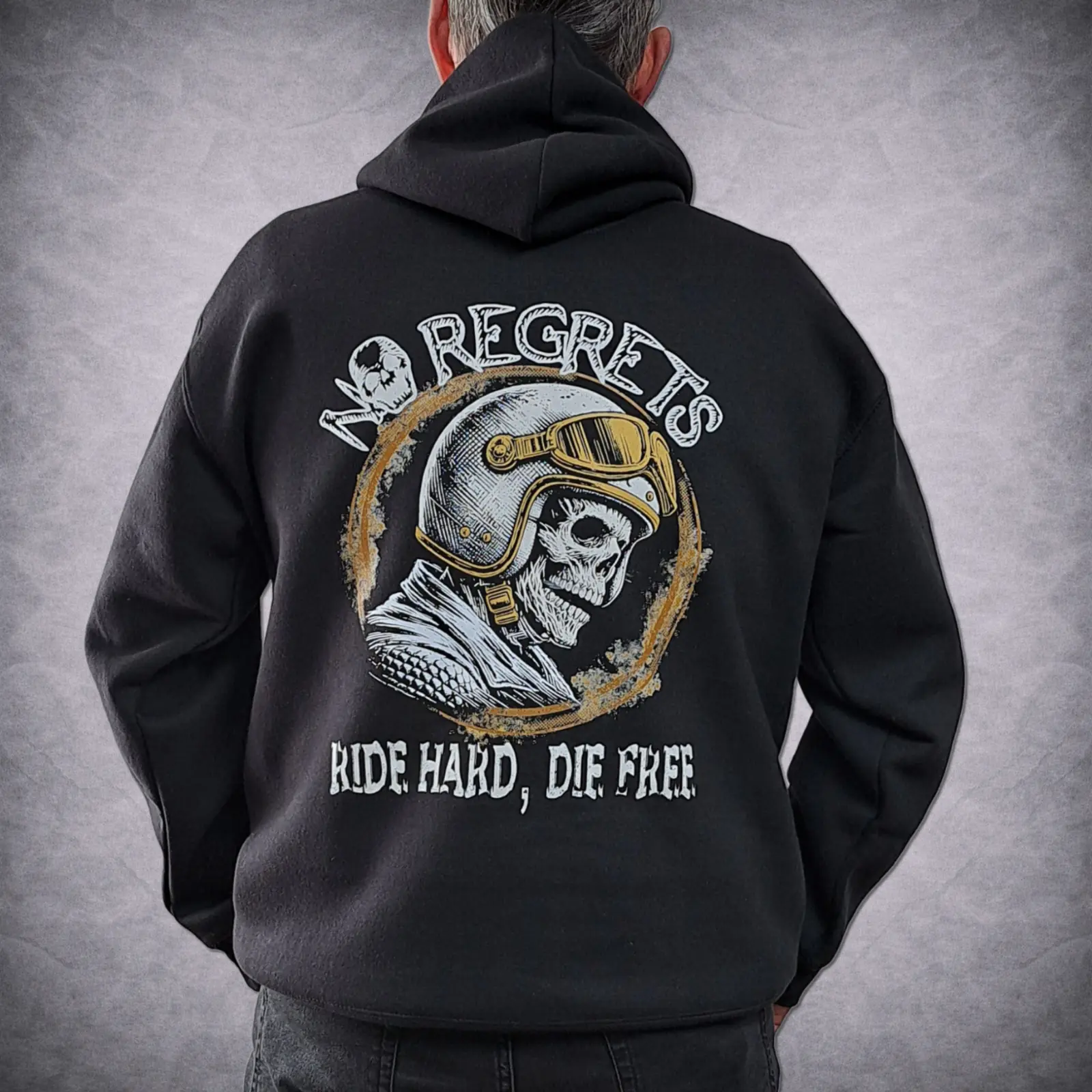 Skull Biker Hoodie – Ride Hard Die Free “No Regrets” Motorcycle Hoodie 7 No Regrets motorcycle lifestyle hoodie featuring a skull back print graphic worn by a male model shown from the rear.