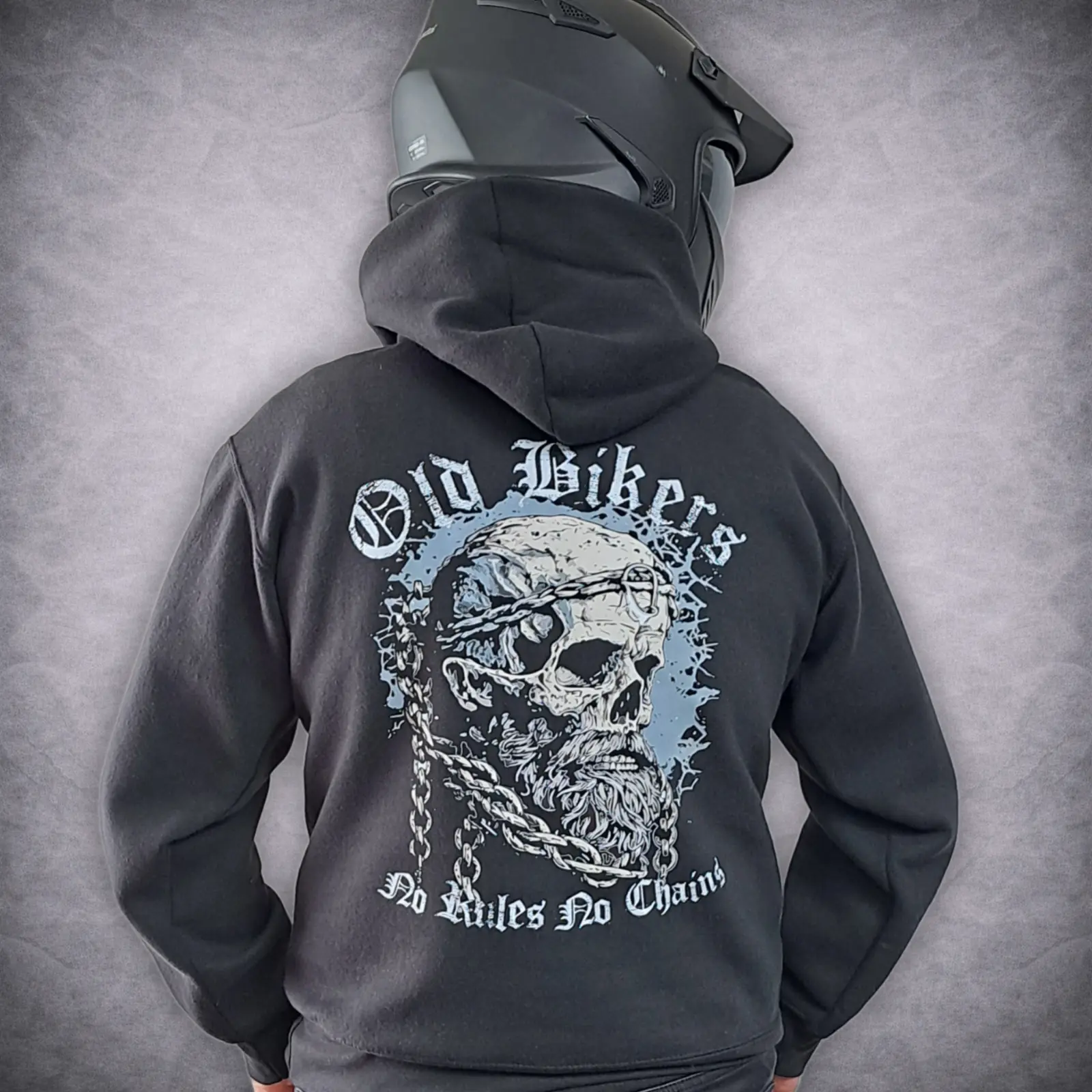 Old Bikers Hoodie – Skull & Chain Motorcycle Hoodie, “No Rules No Chains” 1 Old Bikers skull and chain motorcycle hoodie with a bold graphic back print on a rider wearing a black motorbike helmet.