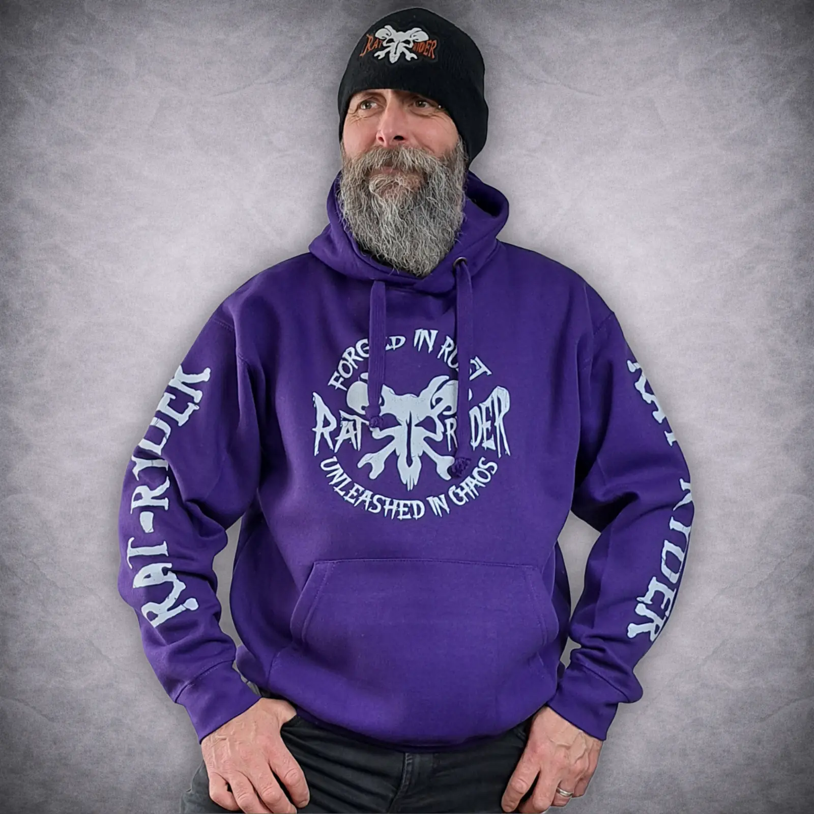 Rat-Ryder Purple Biker Hoodie - Forged in Rust Pullover 2 Angled view of the purple motorcycle pullover hoodie showcasing the large white Rat-Ryder brand typography printed down the sleeves.