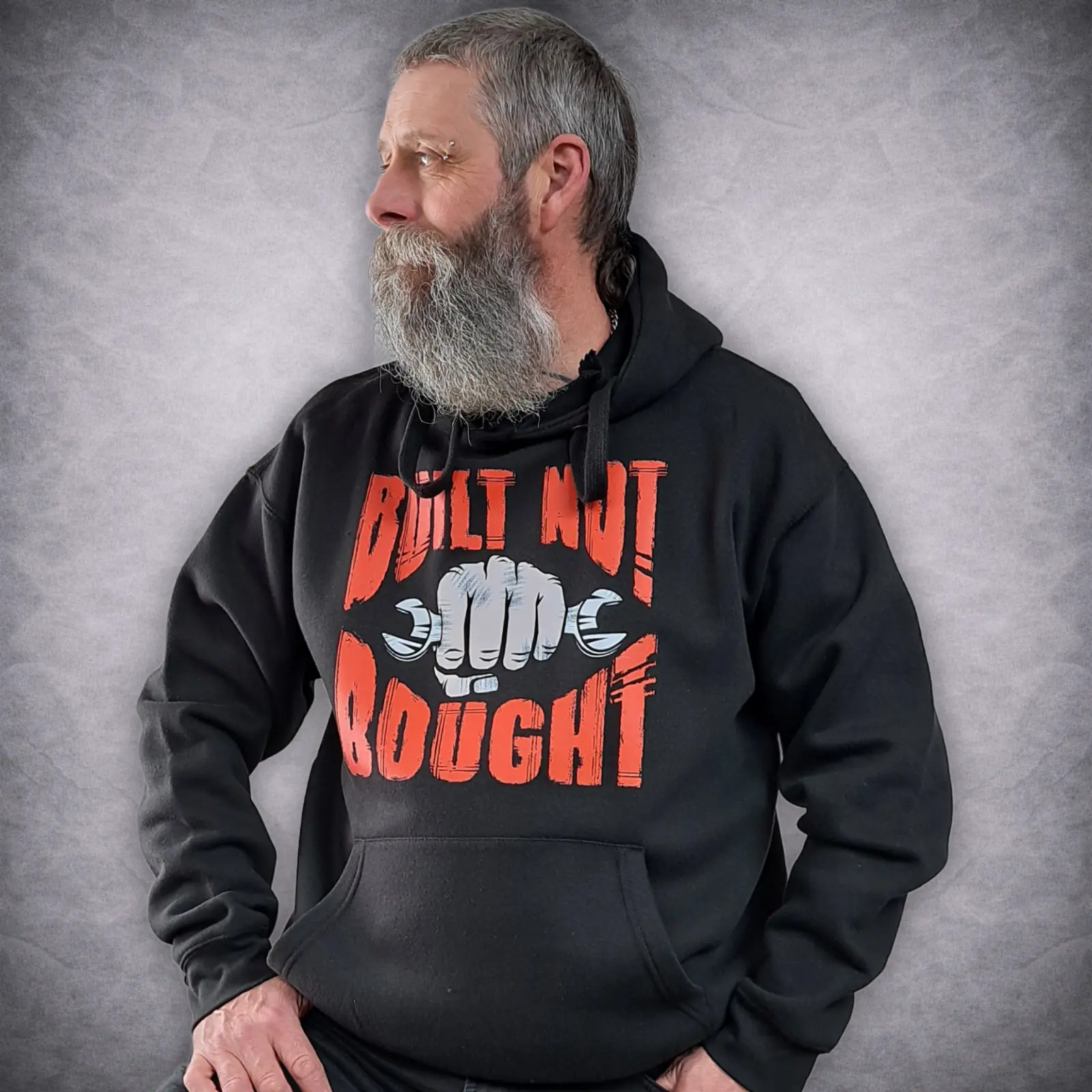 Built Not Bought Biker Hoodie | Motorcycle Mechanic Pullover 4 Side profile of a model wearing the black Built Not Bought motorcycle hoodie.