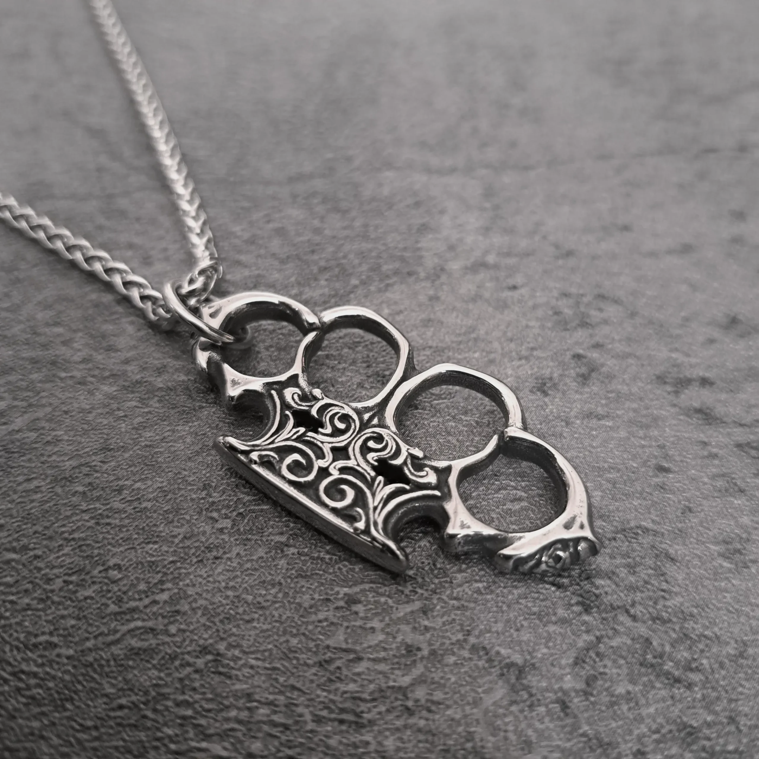 Filigree Knuckle Duster – 316L Stainless Steel Biker Pendant | RatRyder 2 Angled view of filigree knuckle duster stainless steel biker pendant