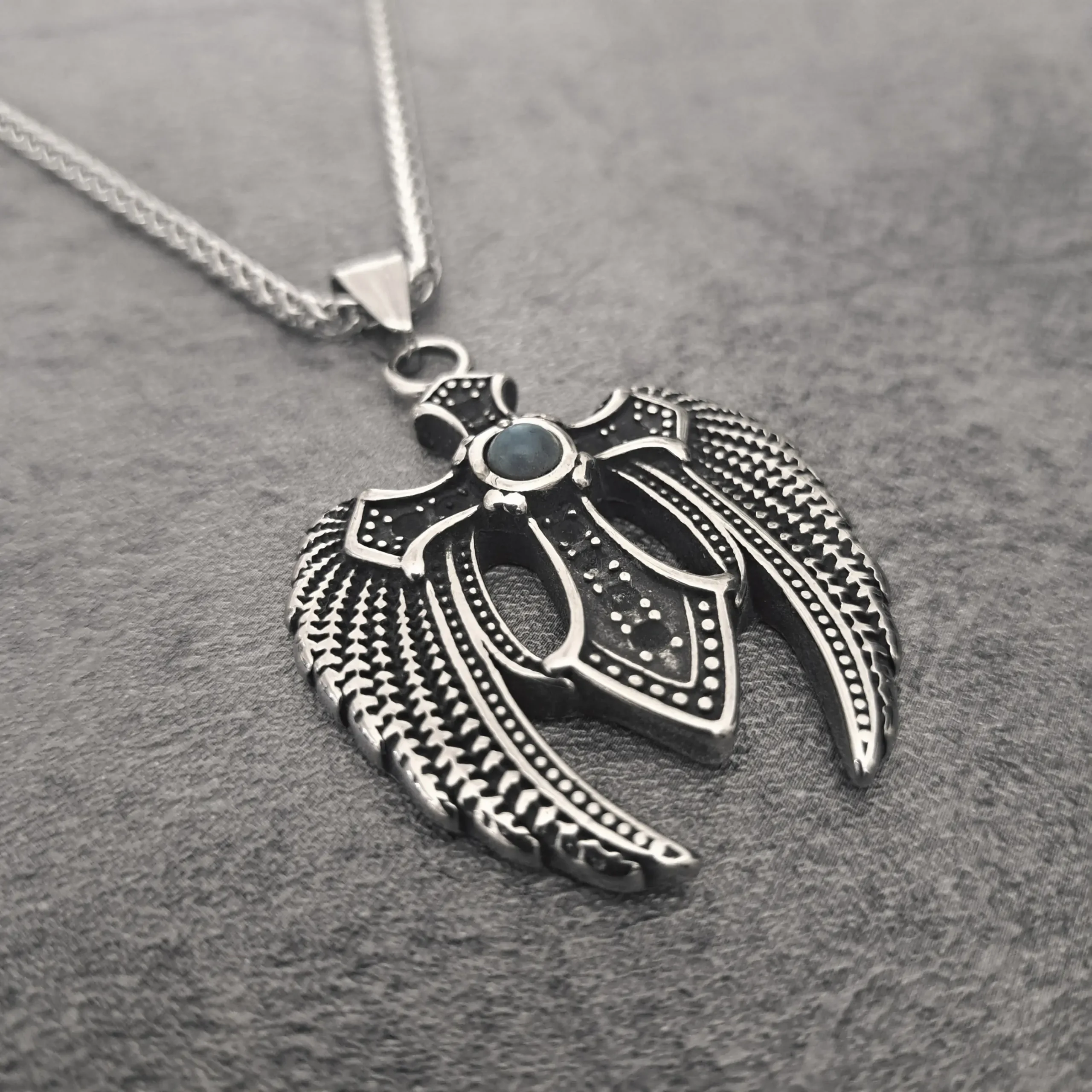 Dark Wing Turquoise Cross – Solid 316L Stainless Steel Biker Pendant | RatRyder 2 Angled close-up of heavy-duty stainless steel biker jewellery winged turquoise cross pendant