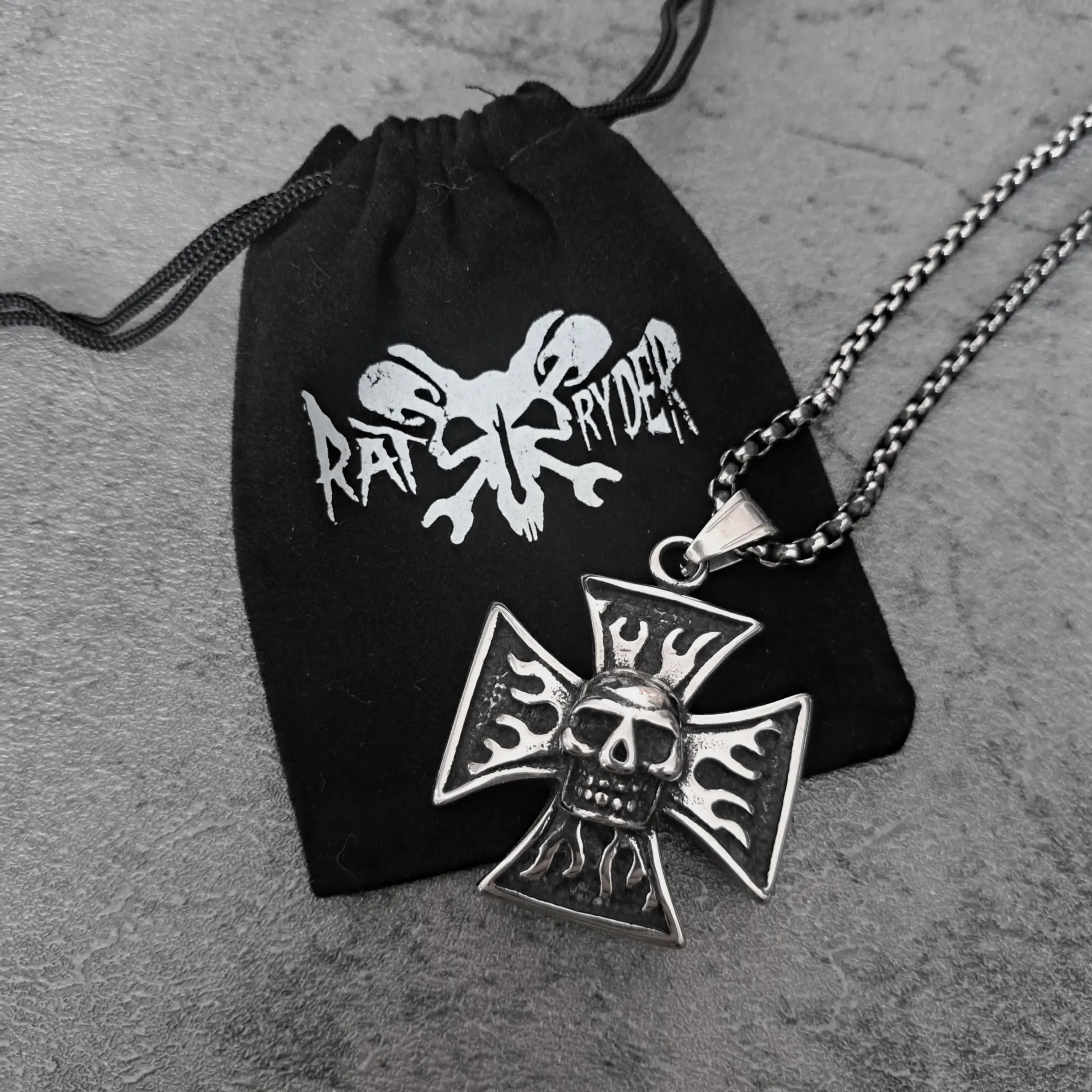 Iron Cross Skull Flame – 316L Stainless Steel Biker Pendant | RatRyder 3 Iron Cross skull flame biker pendant resting on black RatRyder velvet gift bag