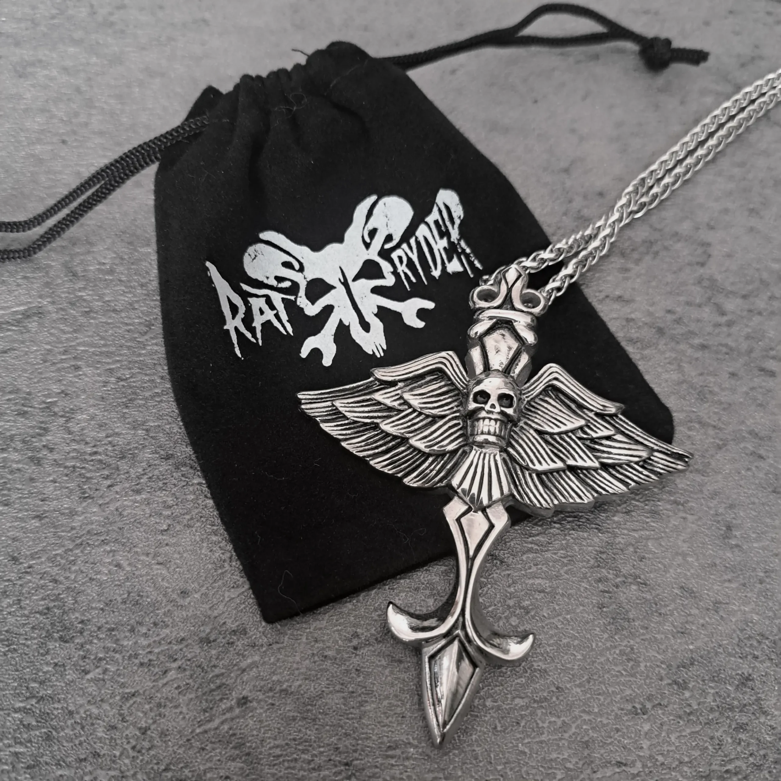 Shadow Wing Skull Cross Biker Pendant – Large Solid 316L Stainless Steel Necklace | RatRyder 3 Large solid 316L stainless steel shadow wing skull cross biker pendant on black RatRyder gift pouch
