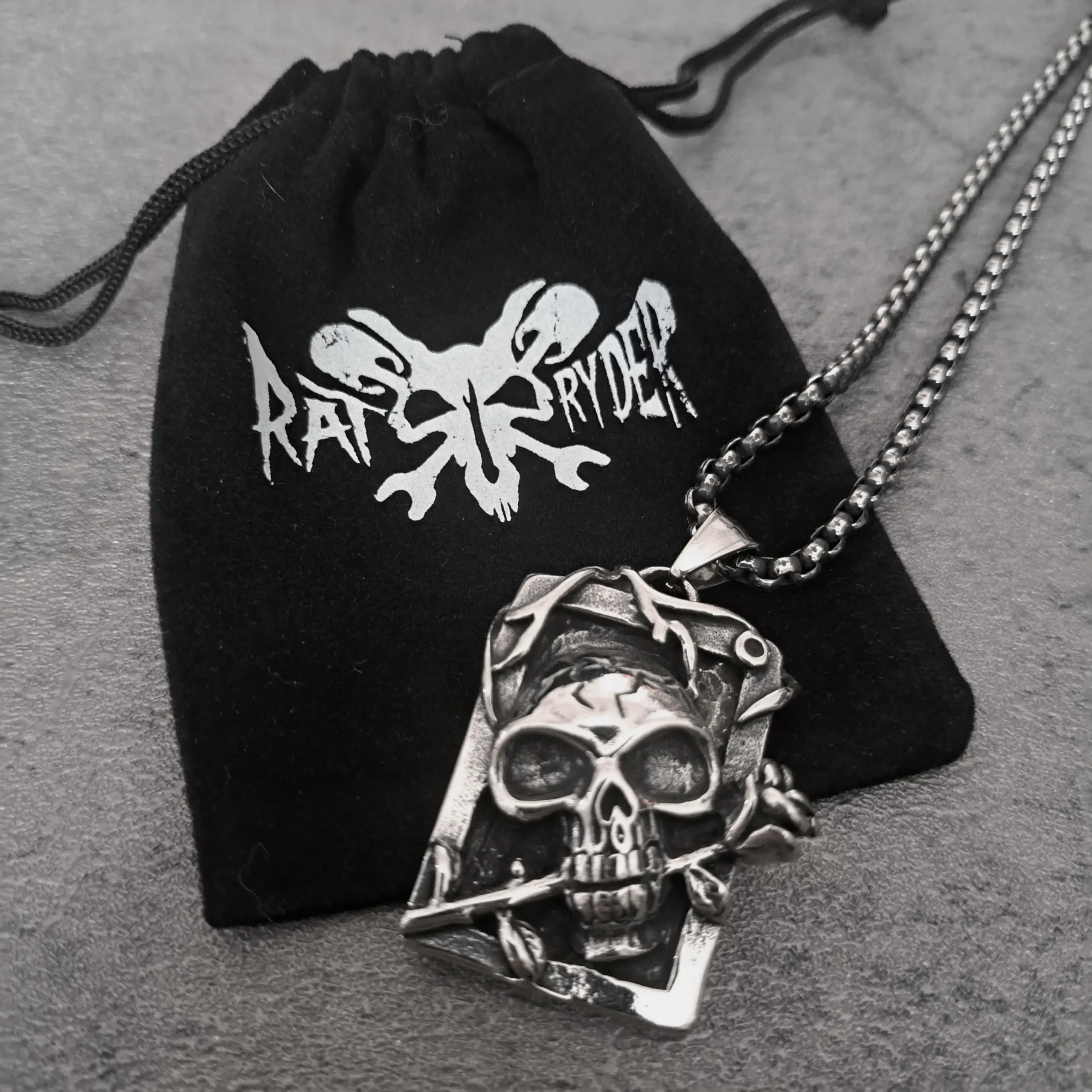 Skull & Rose Tarot Card – 316L Stainless Steel Biker Pendant | RatRyder 3 Skull and rose tarot card biker pendant resting on black RatRyder velvet gift bag