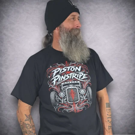 Angle shot of Piston N Pinstripe car tee on model showing high detail Kustom Kulture graphic print and black beanie