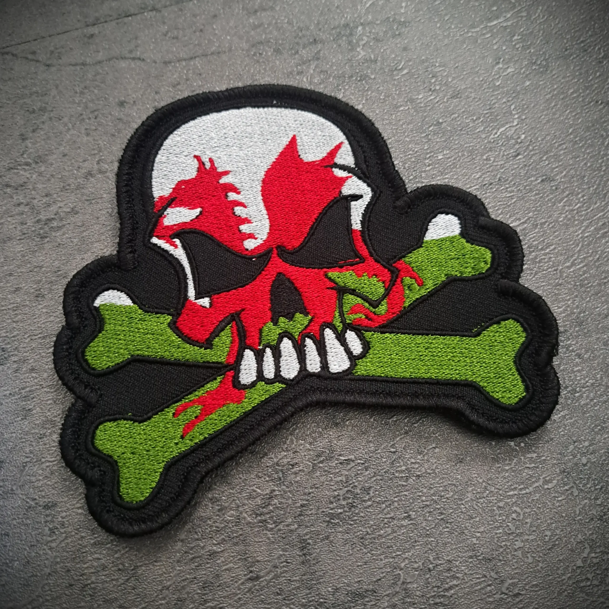 Wales Flag Skull Embroidered Biker Patch – Sew On | Rat-Ryder 2 Angled view of Welsh dragon skull embroidered biker patch showing stitched detail